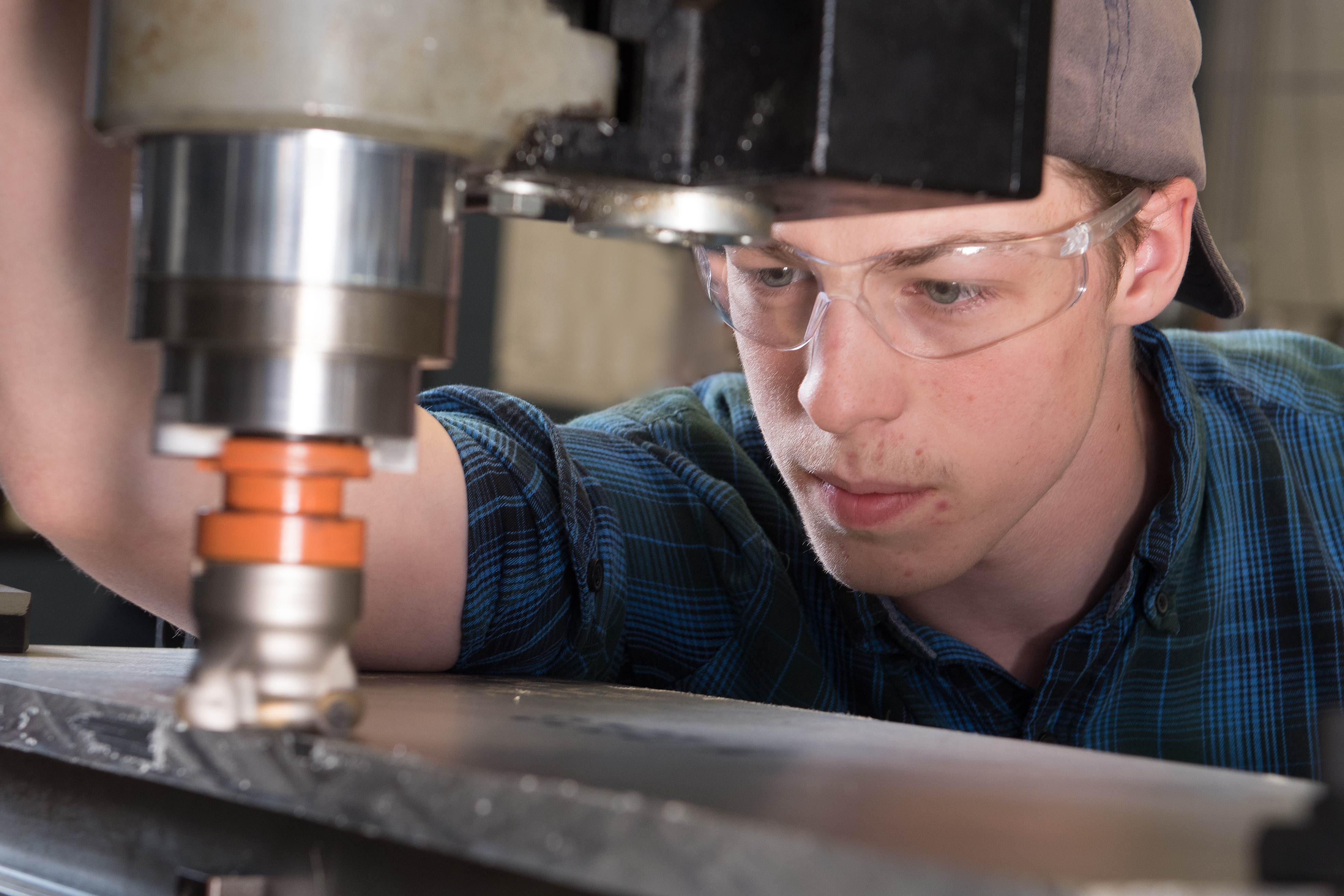 Male student using equipment in the Precision Machining lab