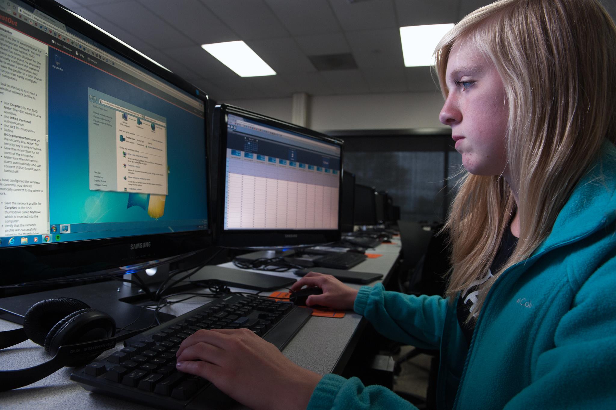 Female Cybersecurity student works on her computer in the classroom