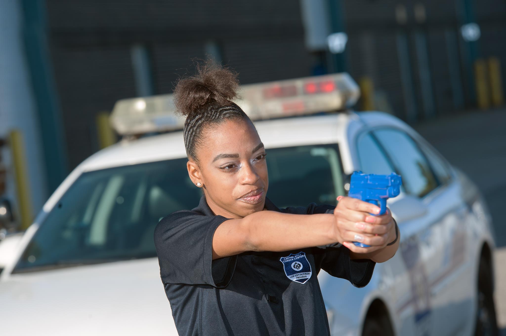 Female Law Enforcement student practices her shooting skills