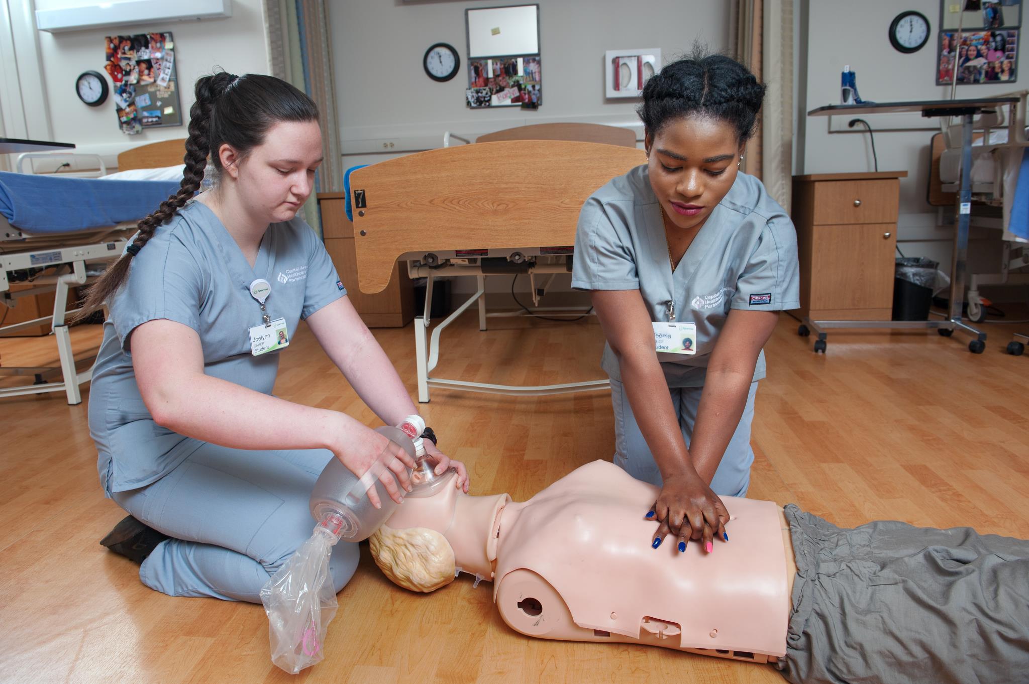 Two female health students working on their CPR skills