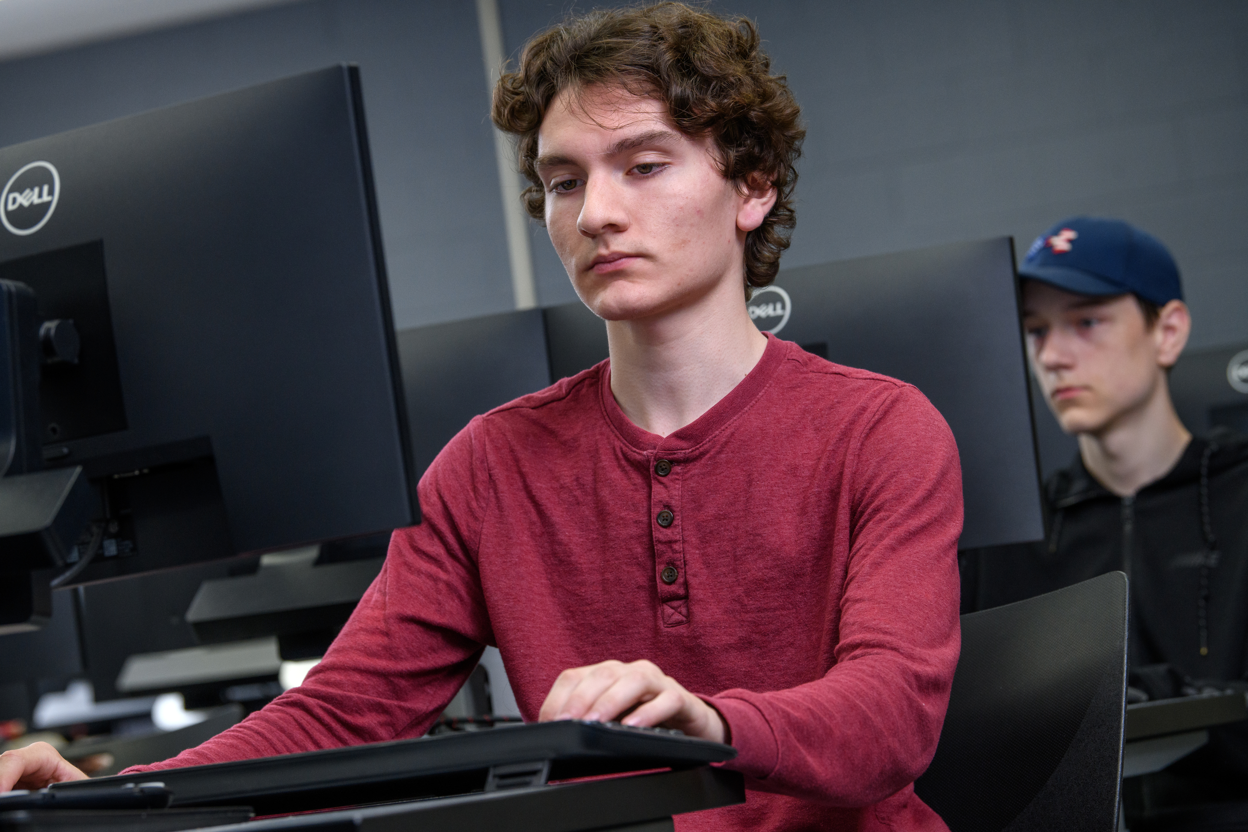 Cybersecurity student working on his computer in the lab.