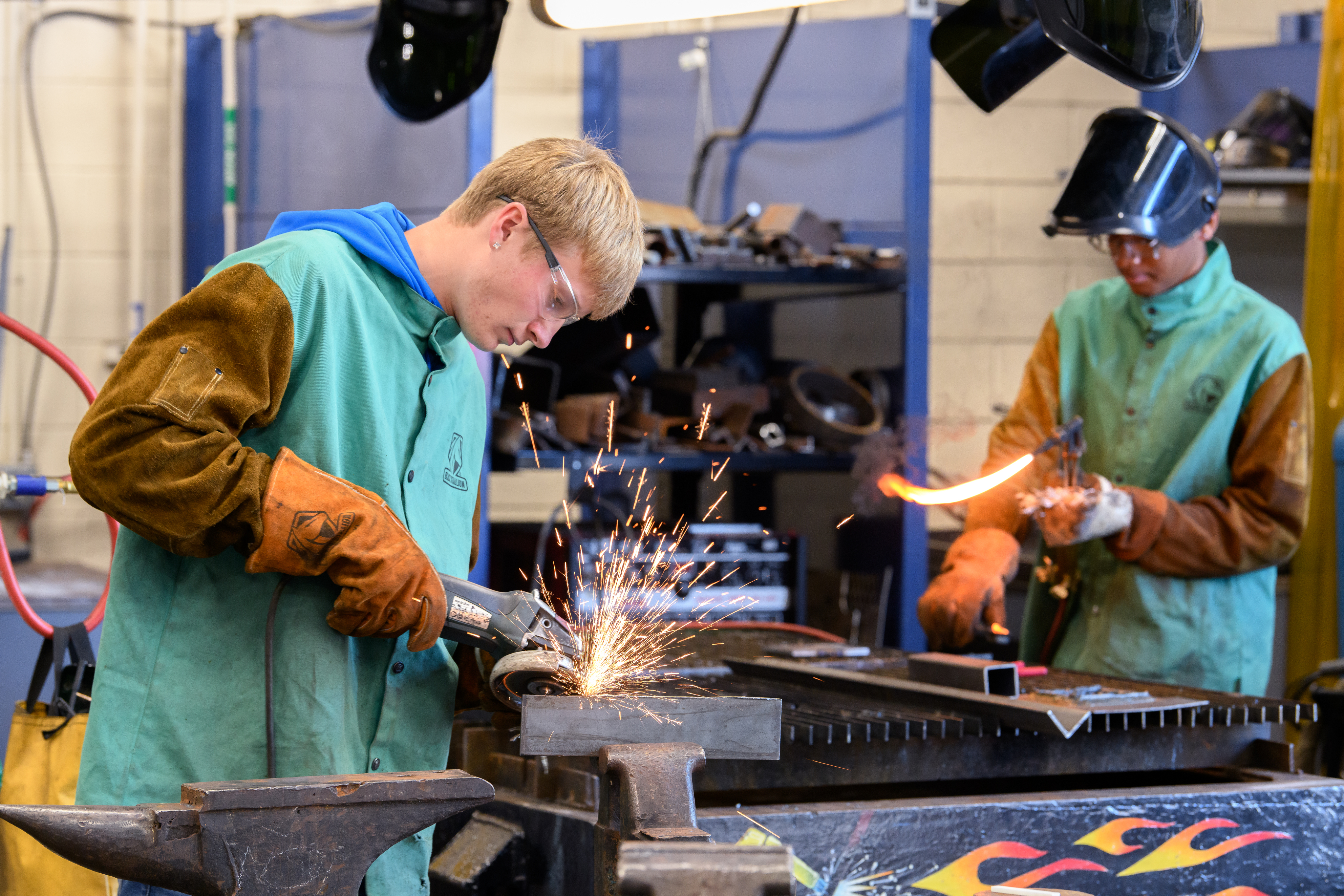Two welding students working in the lab together.