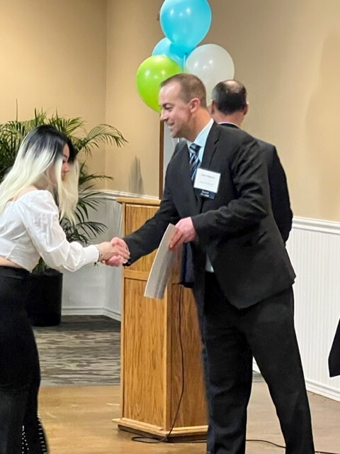 Ingham ISD Superintendent, Jason Mellema, presents a scholarship check to Wilson Talent Center senior, Thu (Skye) Vo.