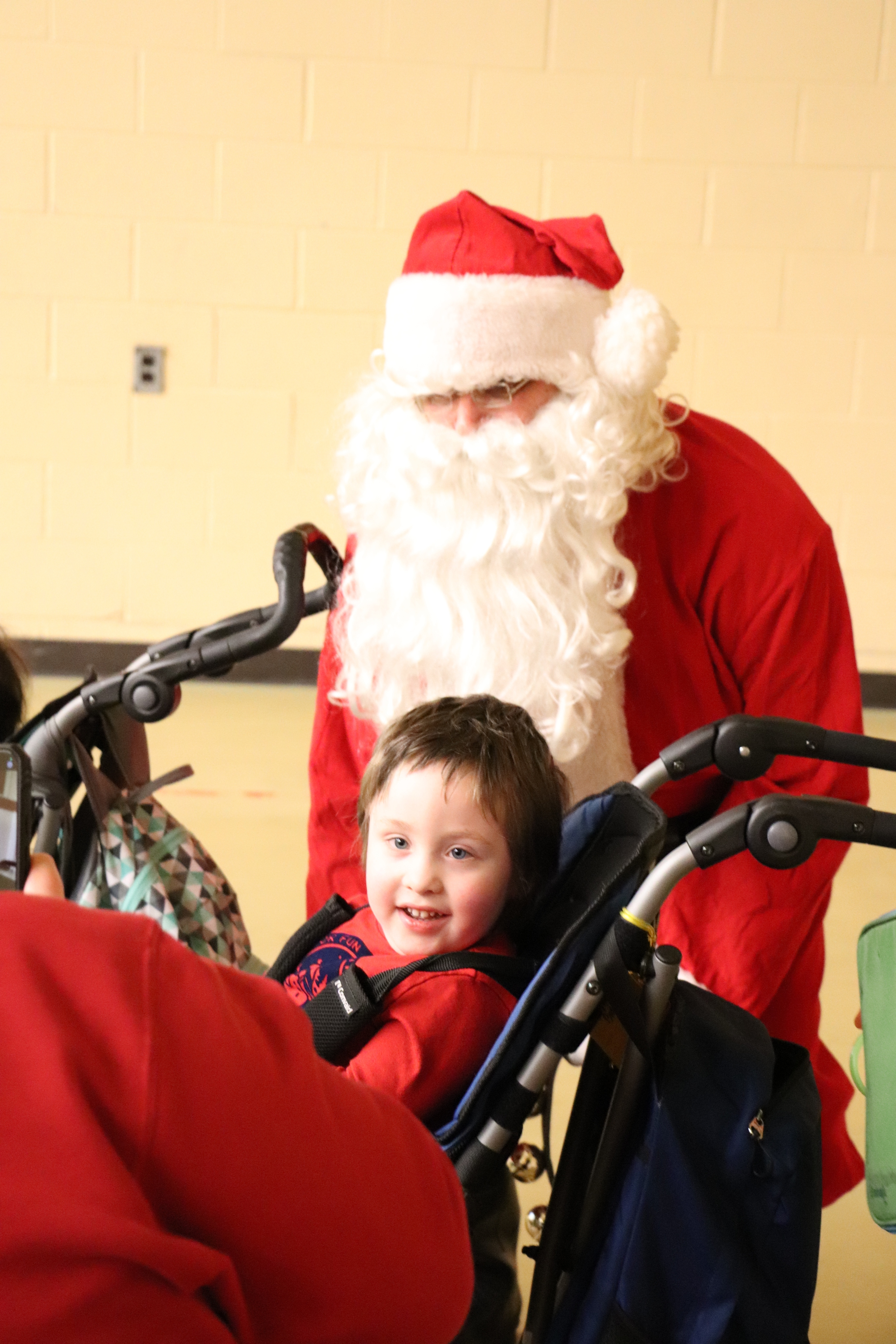 Santa talking to a young girl in a wheelcrair